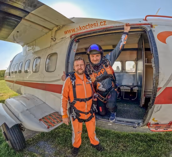 tandem instructor and tandem passenger on the ground in front of an aircraft